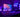 Setup PC gaming avec boîtier et éclairage RGB violet/bleu, écran et clavier — ambiance bureau gaming